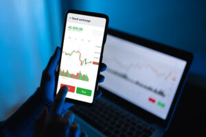 Trader using stock exchange app online for trading operations and Personal Finance